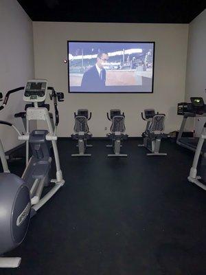 Cinema room with bike and treadmill view