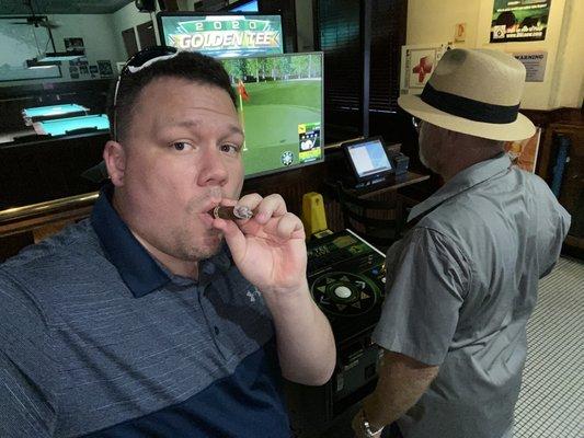 Us enjoying our cigars all while playing some Golden Tee!