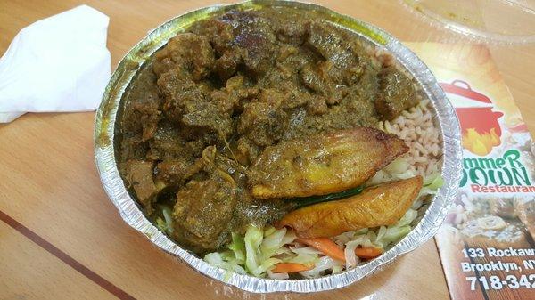 Large plate of curry goat w/rice and pease. A side of cabbage & sweet plaintains included.