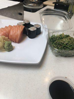 2 orders of salmon sashimi, one yellowtail roll and seaweed salad.