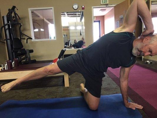 Running Coach doing the Pilates Side Kick Kneeling