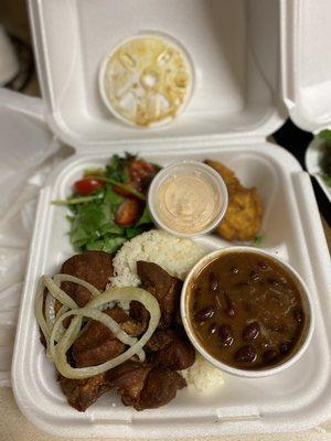 This is the fried pork chunks with rice and beans.