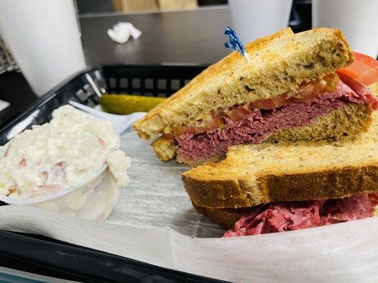 Hot Corned Beef Sandwich on rye with deli mustard & side of red skinned potato salad