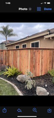 Top cap red wood fence.