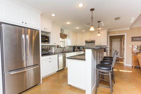 Kitchen view with raised bar top.