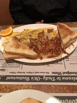 Veggie omelette with bacon added, hash browns and toast.