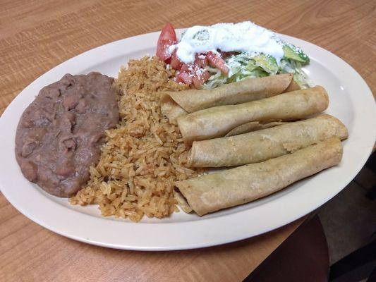 Taquitos de papa. Salad on the side instead of on top, keeps the taquitos warm and crunchy.