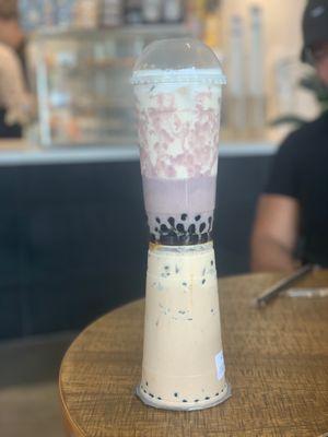 Hokkaido caramel milk tea with tiramisu foam and golden boba on bottom and taro tea with cheese foam