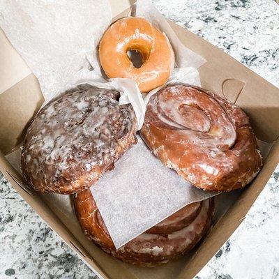 Apple fritter, glazed donut, cinnamon roll