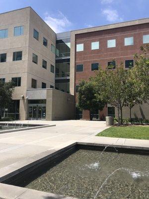 Behind the building , benches and soothing waters