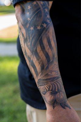 Half sleeve patriotic tattoo by Ricky