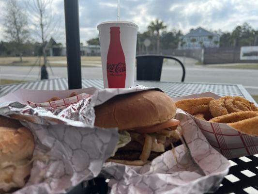 Double Burger w sautéed onions and onion rings on patio