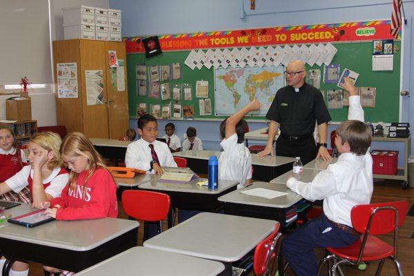 Father Miles, the school Chaplain visits the 6th grade class.