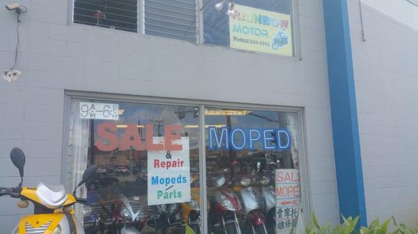 The shop is on the corner. Look for the small yellow sign and the mopeds out front.