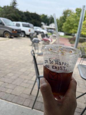 Enjoying a delicious Cold Brew sitting outside on a comfy armchair.