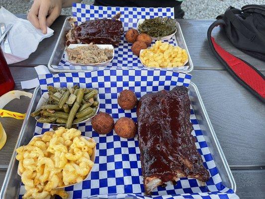 Ribs, Mac and cheese, green beans, collards, and hush puppies