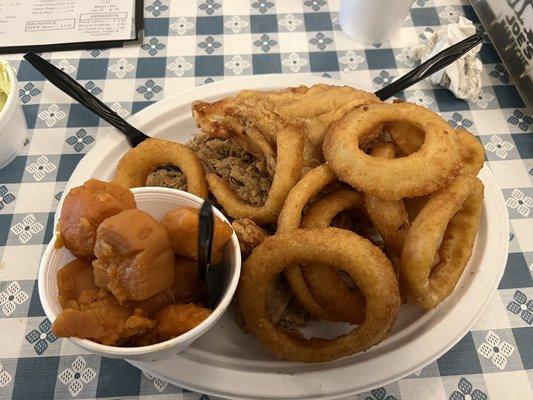 Platter with pulled pork, fried chicken, onion rings, yams,