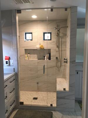 Steam shower enclosure showing notched buttress glass panel.