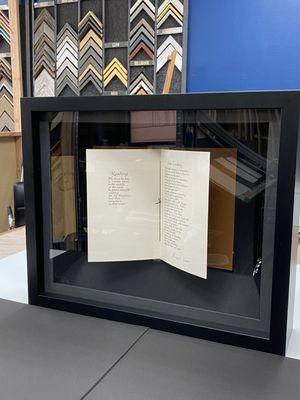 Mirrors show the front and back of the open book.