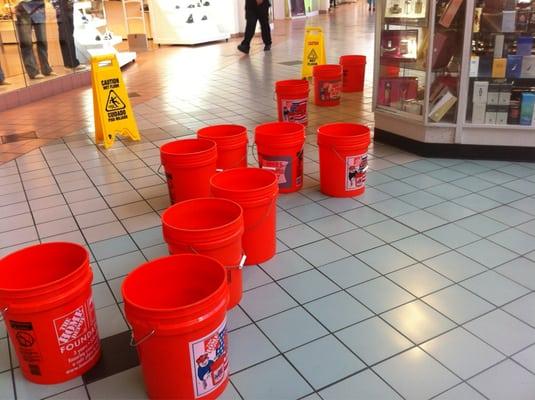 Buckets to catch the leaks from the ceiling.