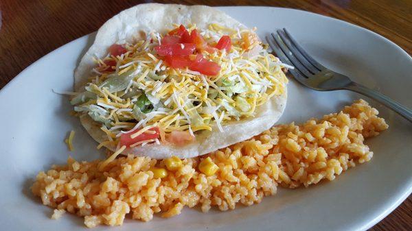 Lunch soft taco with a side of rice.