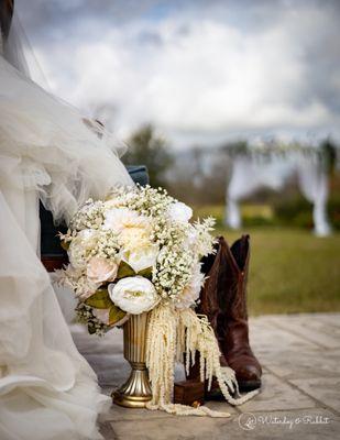 Bridal bouquet & decorated pergola in back.