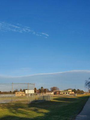 Beautiful Blue Sky with Cloud Mountain Pattern while passing by the Empty Baseball Diamonds.  Thursday 12/14/2023