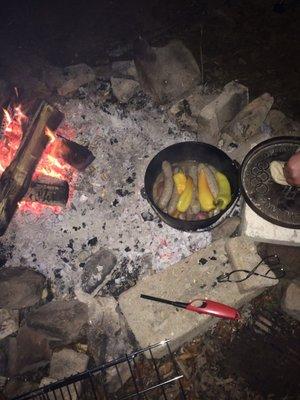 Amazing Bells sausages and peppers being cooked in our Dutch oven