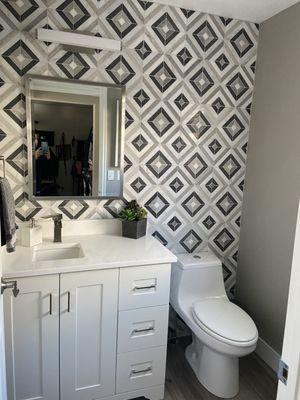 new bath tile, vanity, mirror and light fixture