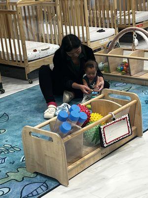 Ms Nikko teaching my son how to push down on a toy. So gently and caring