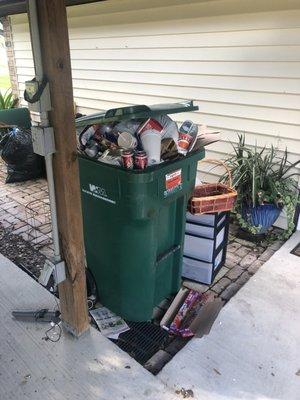 Overflowing garbage not bagged falling out of trash can, good basket filled with merchandise left for grieving family to put up