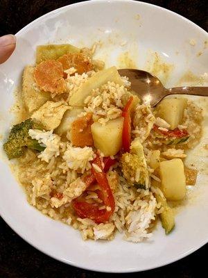 Yellow curry with veggies, red peppers, chicken, broccoli and potatoes.