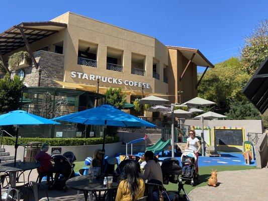 Playground with parakeets enclosure, and Starbucks and Whole Foods above