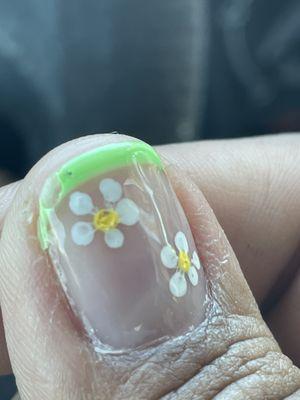 Chipped gel manicure, excess top coat polish and half-assed flower design