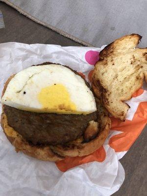 Half an egg on sausage and egg croissant