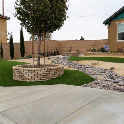 Drought tolerant, low maintenance desertscape with EasyTurf synthetic lawn highlights keep this curb appeal always looking great.