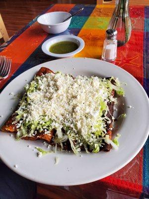 Two chicken and two cheese enchiladas with mole sauce, lettuce, sour cream, and cheese.  They were excellent!