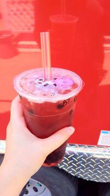 Raspberry black tea with boba. Cute cup lid!