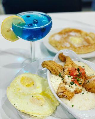 Catfish& Grits with a side egg and pancake that's not included in the entree