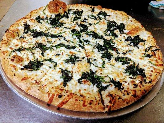 Spinach & Feta -  A white Pie, with olive oil, mozzarella, fresh baby leaf spinach and Feta cheese and minced garlic.