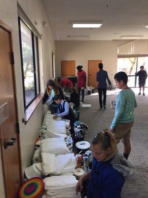 Our youth group helping fill out welcome baskets for the families entering the Ochoa Migrant Center