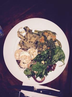 8oz Filet topped with sautéed shrimp in a garlic herb butter paired with rustic vegetables and a warm spinach salad.