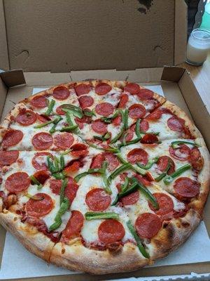 Large pepperoni and green bell pepper pizza