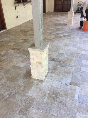 Travertine wrapped columns and tumbled travertine pavers set in random pattern.