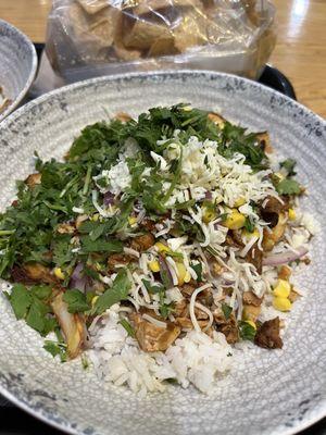 Classic Bowl with Rice, Sweet Potatoes, Chicken, Veggies, Spicy Red Sauce, Queso Sauce, Cheese and Fresh Cilantro.