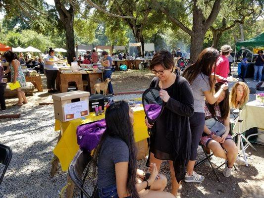 Bling strings and sprat on hair color at Peninsula School Spring Fair