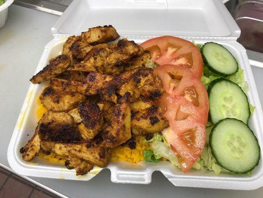 Chicken kabob over rice and salad