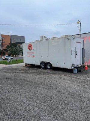 The back of the food truck and the parking lot area