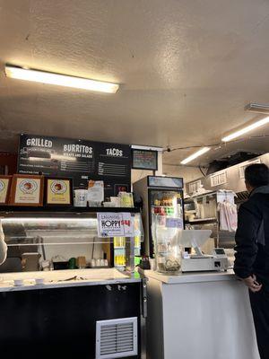 Menu, salsa bar and cash register.