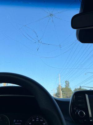 Broken windshield caused by the dealership